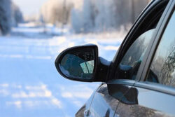 sedan car with broken mirror in winter driving