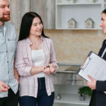 auto glass insurance agent talking to a couple about their policy coverage