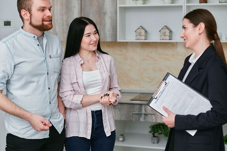 auto glass insurance agent talking to a couple about their policy coverage