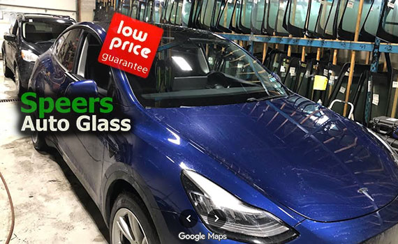 blue Tesla model 3 needs front windshield replacement in Speers Oakville shop